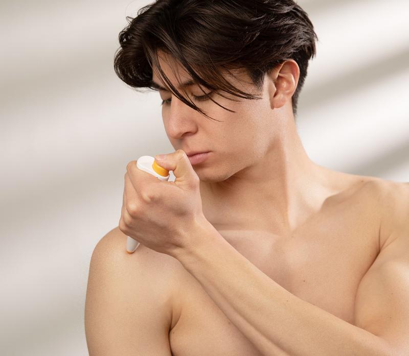 Person applying the Paingone Plus TENS pen to a shoulder