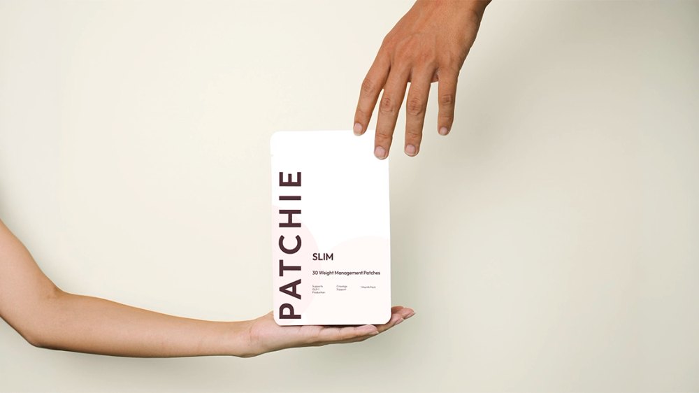 A hand holding a single Patchie patch pouch