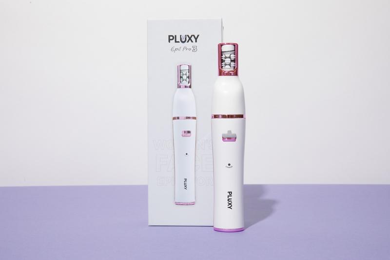 The white Pluxy Epil Pro facial epilator standing next to its retail box
