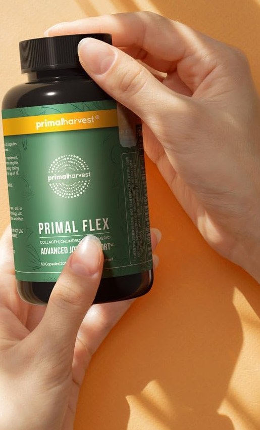 Hand holding a bottle of Primal Flex joint support by Primal Harvest
