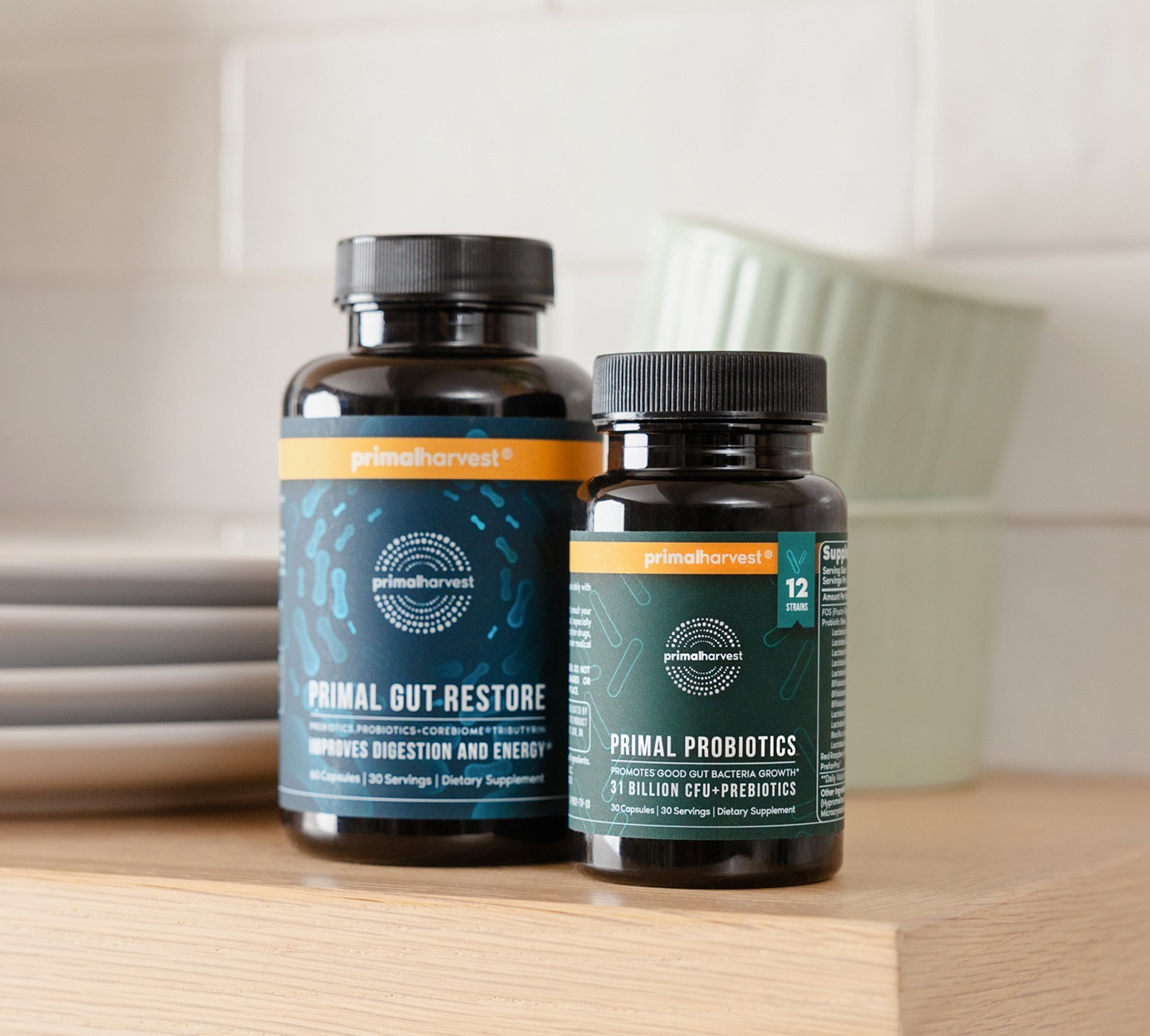 A bottle of Primal Gut Restore next to Primal Probiotics from Primal Harvest on a kitchen shelf