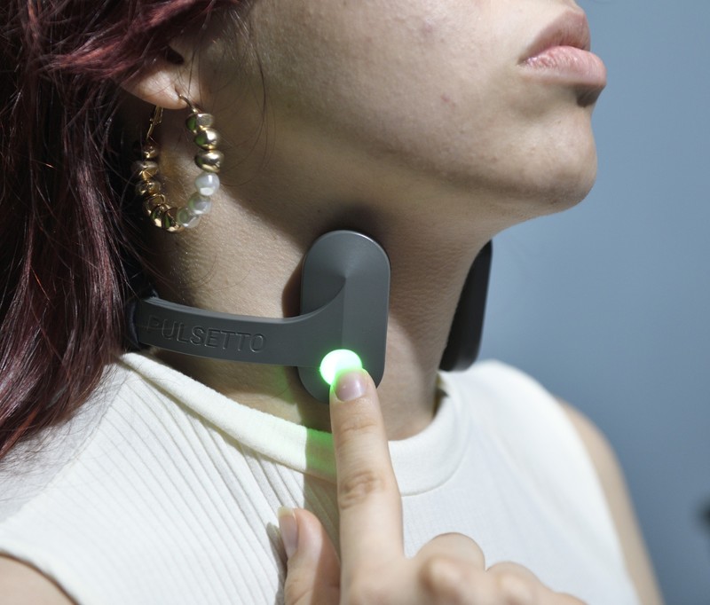Close-up of the Pulsetto vagus nerve stimulator collar and its control button