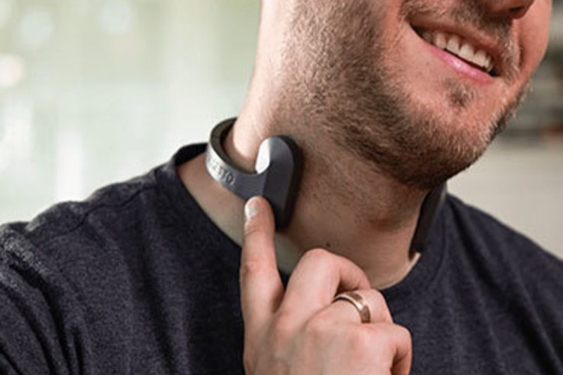 Person wearing the Pulsetto vagus nerve stimulator collar and adjusting it at the neck