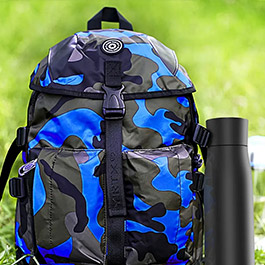 Pura UV smart bottle clipped to a backpack outdoors for travel