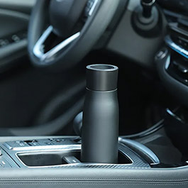 Pura UV smart bottle sitting in a car cup holder