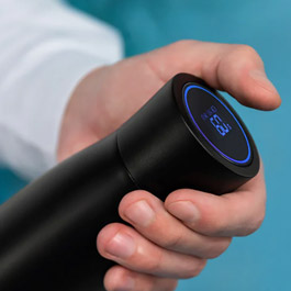 Pura UV smart bottle held sideways showing the temperature reading on the touch-sensor cap