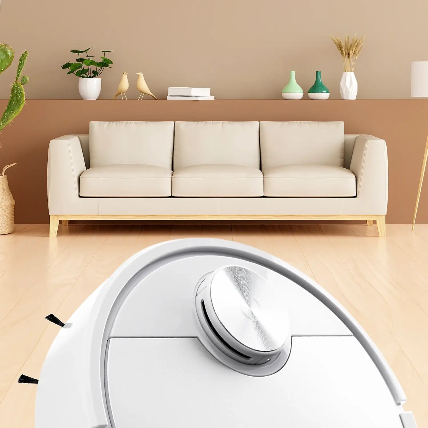 The white RoboVac X robot vacuum cleaning a wood floor in front of a sofa