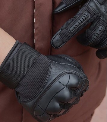 Ruck & Recon tactical gloves worn on both hands, showing the fit across the knuckle guard and wrist strap