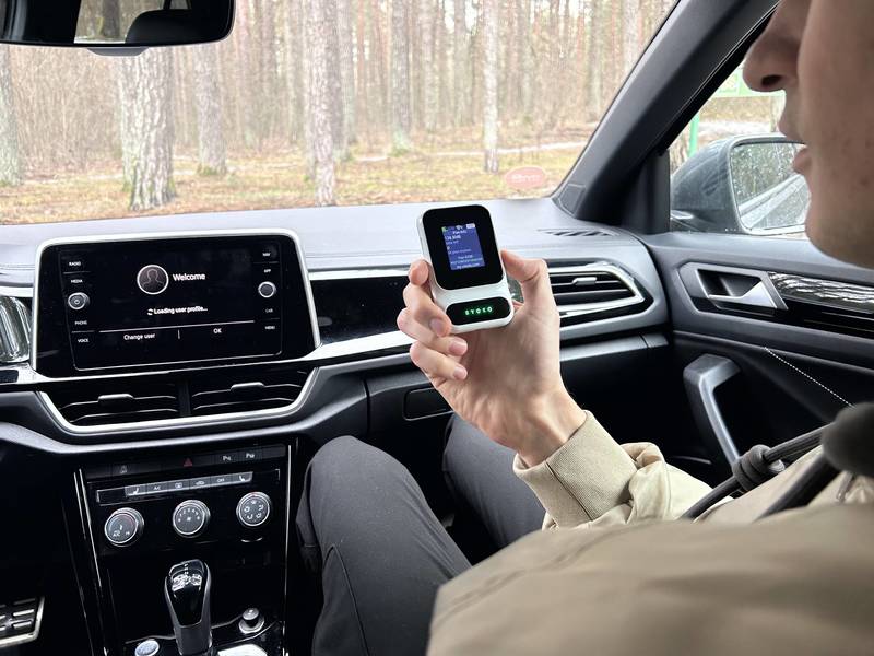 Ryoko Pro portable WiFi hotspot held in a car on a road trip