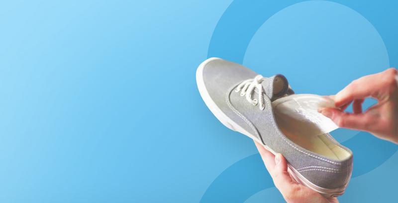 Soul Insole gel pod being placed into a grey canvas shoe
