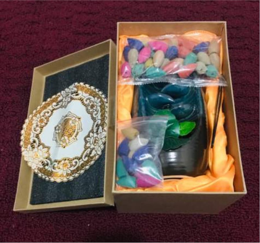 Bags of colorful Spirual backflow incense cones included with the burner