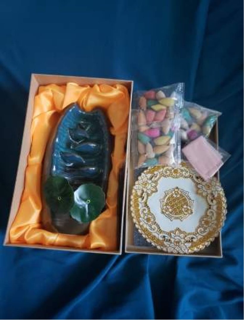 Spirual incense waterfall in its gift box beside bags of colorful backflow incense cones