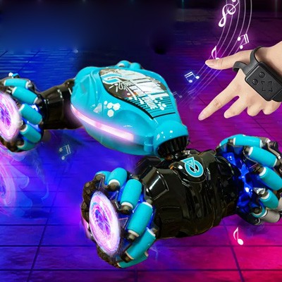 A hand wearing the Orbi RC Car gesture-sensing wrist band beside the light-up car