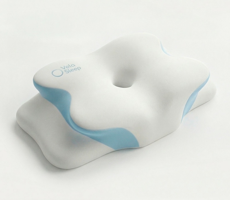 The VelaSleep 4-zone contour memory foam pillow shown from the front with its blue and white sculpted shape
