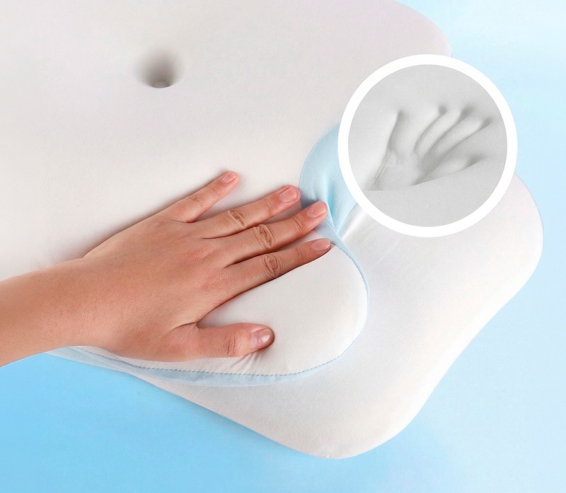 A hand pressing into the VelaSleep memory foam to show how the slow-rebound surface compresses