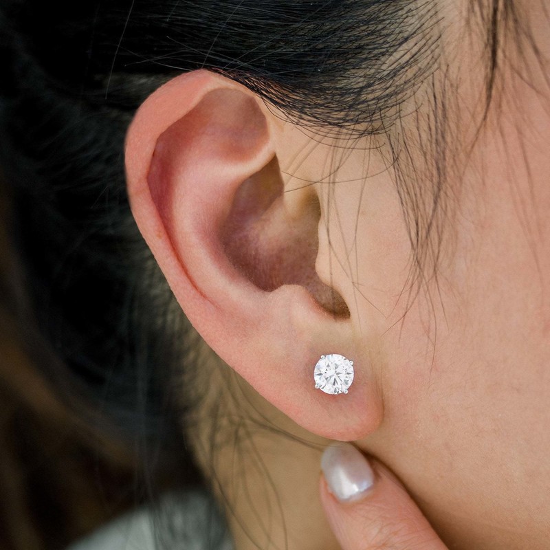 A close view of a Voss + Agin lab-grown diamond stud earring worn on the ear