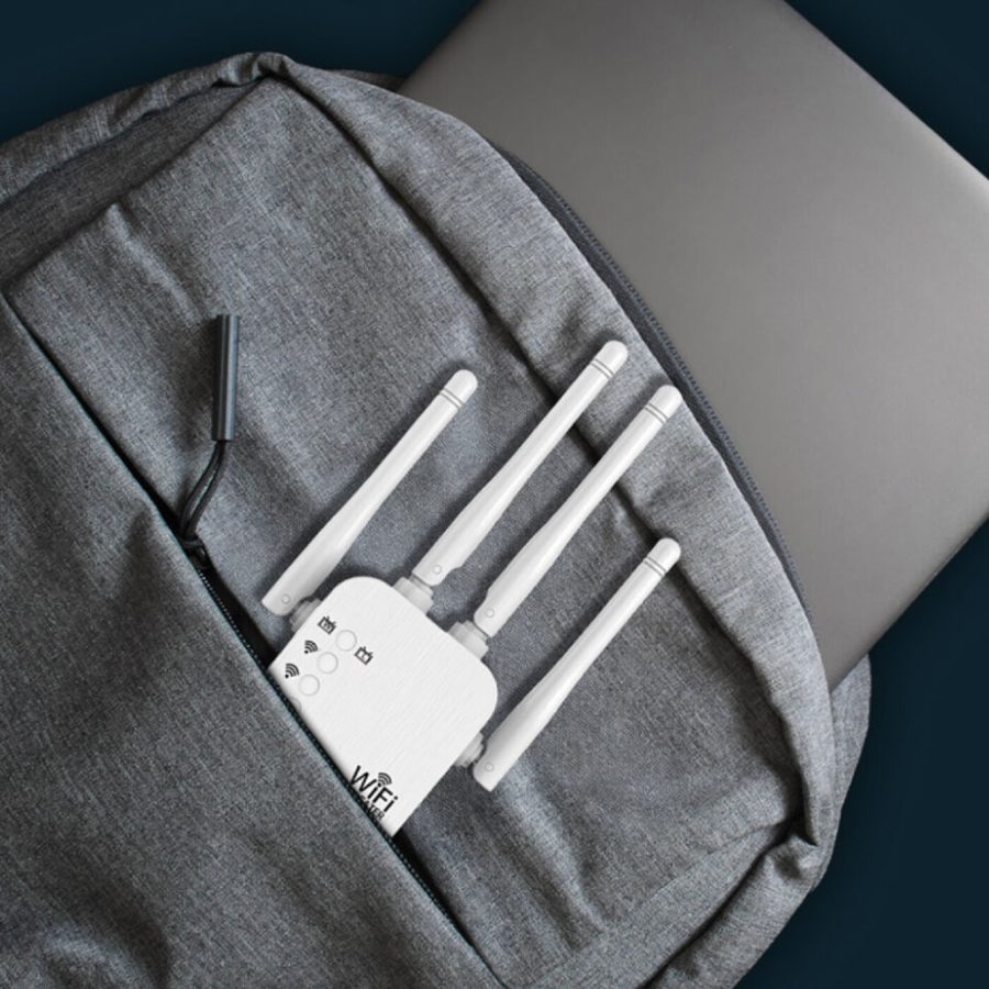 WiFi Boost Pro extender tucked into a laptop backpack pocket for travel