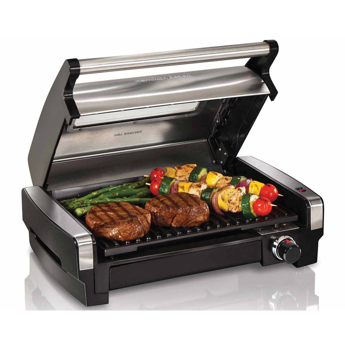 Hamilton Beach electric indoor searing grill with the stainless lid open and food on the grate